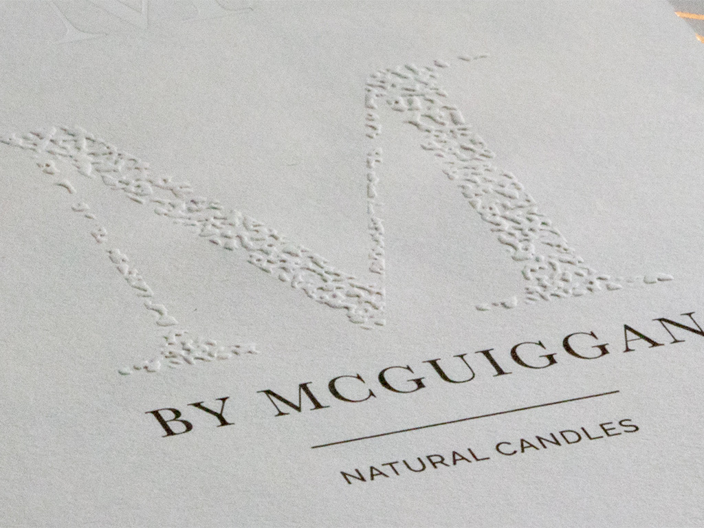 M Emboss Close-up of a luxury label with an embossed logo