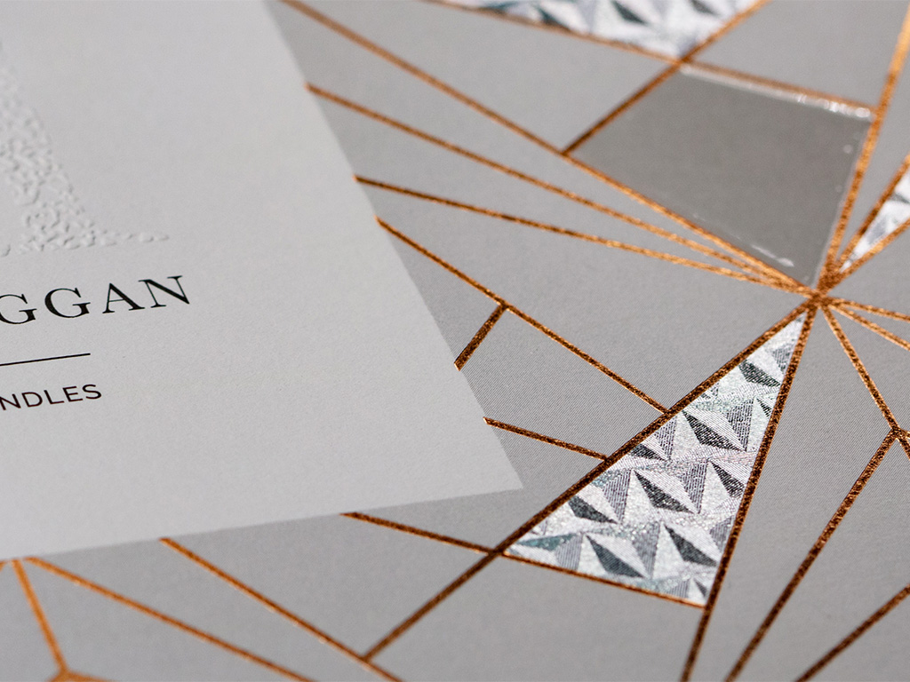 3D hot foil triangeles Close-up of a luxury label with an embossed logo