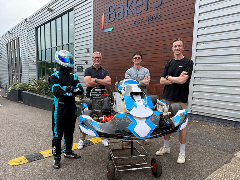 Steve, Harry and Tom Baker with young karting driver Roman Curtis outside Baker Labels